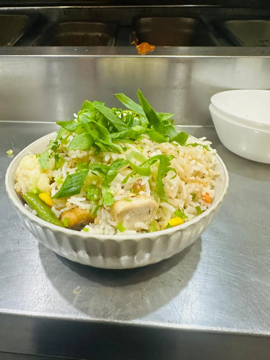 Vegetable fried rice topped with spring onion and coriander at Aura